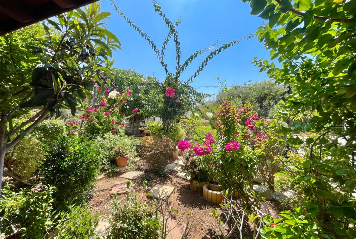 Traditional 3-Bedroom Stone Bungalow Surrounded by a Mature Garden