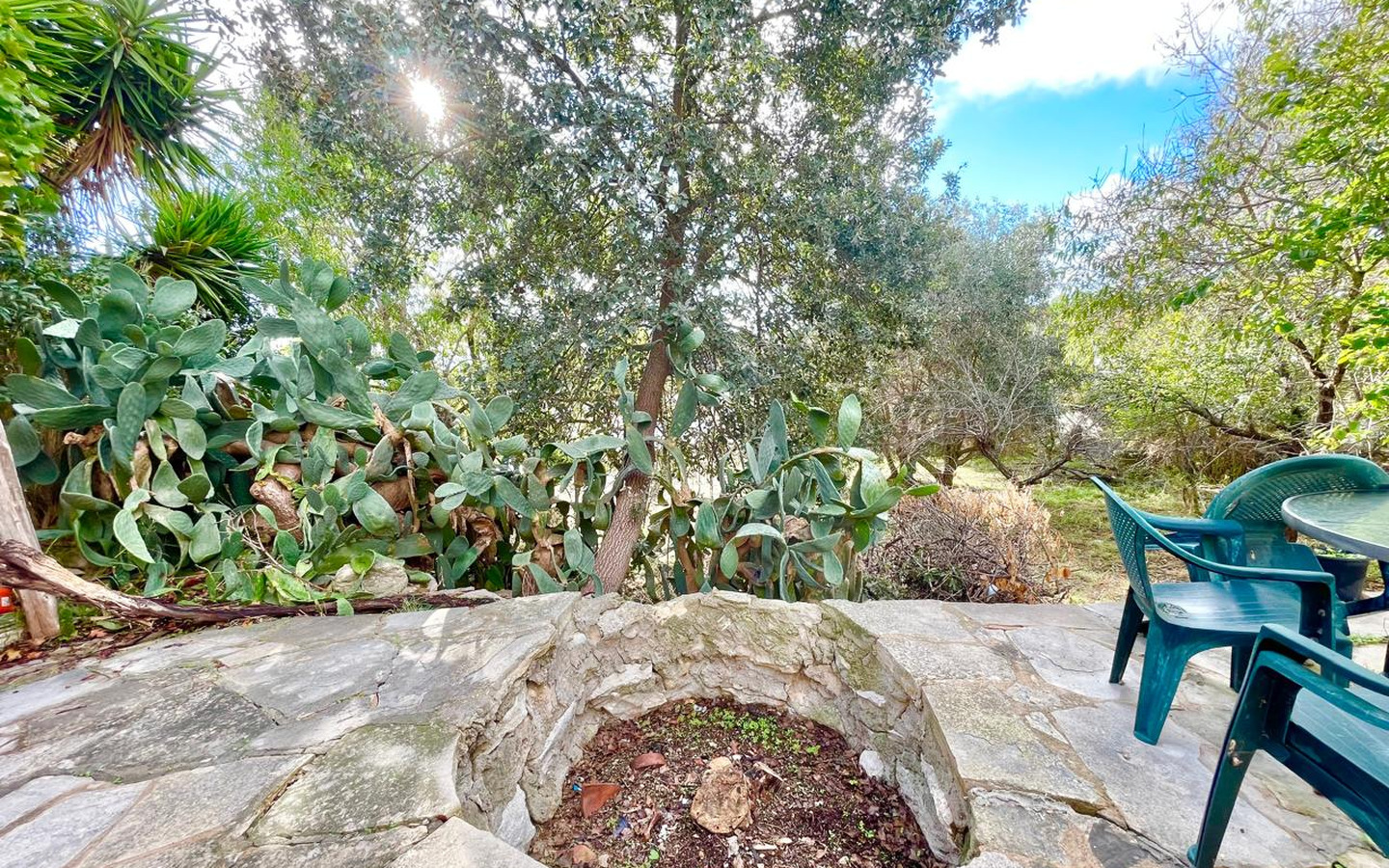 08_Exterior_stone-house-for-sale-paphos-cyprus One-bedroom stone cottage with a fireplace and a beautiful green garden