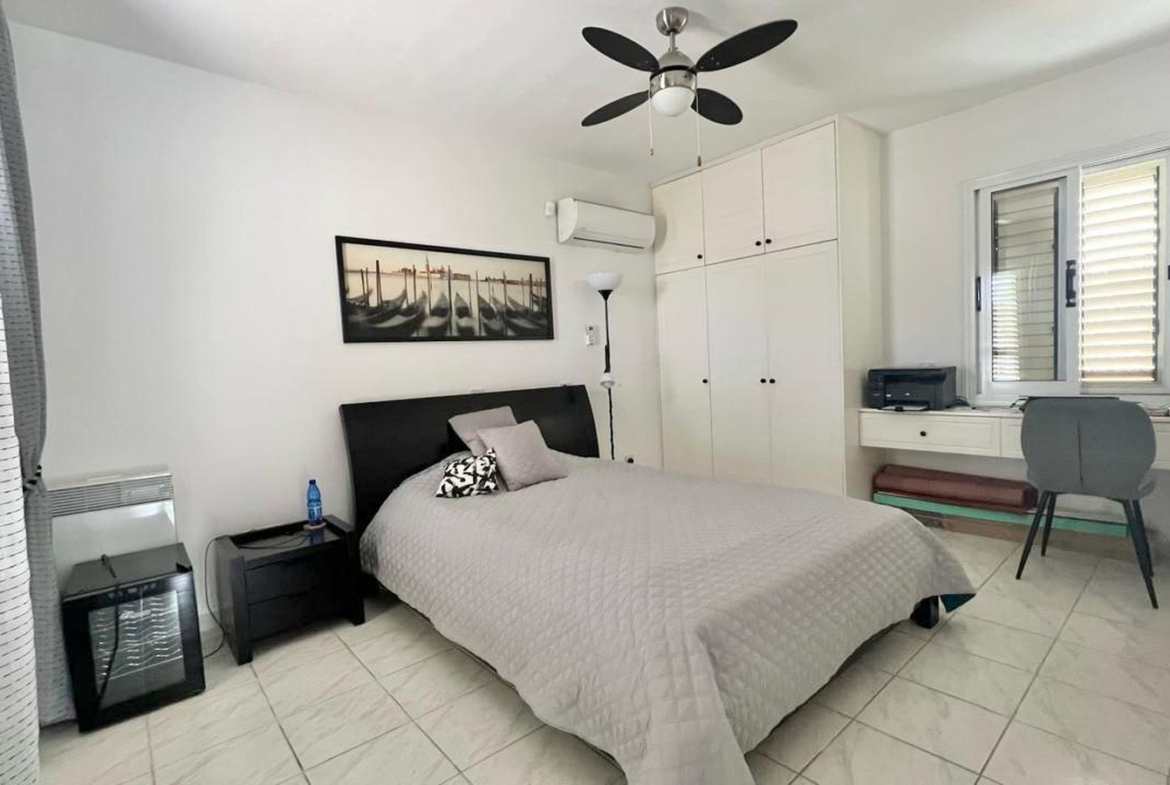 Two-bedroom villa with a private garden and communal swimming pool