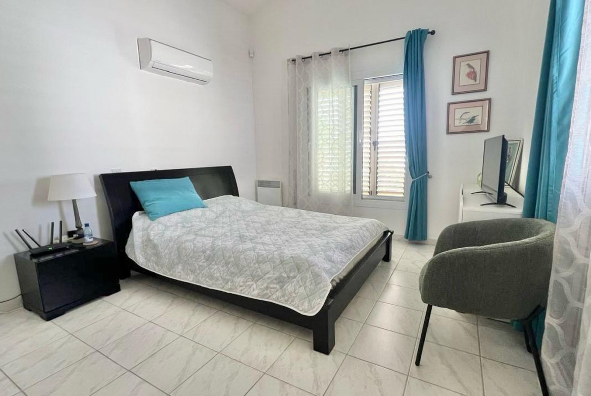 Two-bedroom villa with a private garden and communal swimming pool