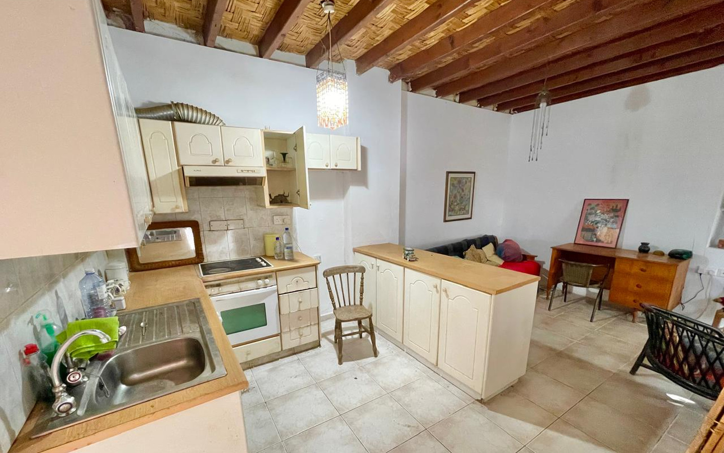 17_Interior_stone-house-for-sale-paphos-cyprus One-bedroom stone cottage with a fireplace and a beautiful green garden